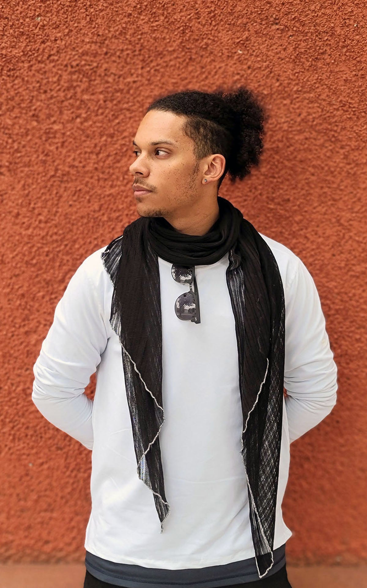 Man modeling Handkerchief Scarf in Voile Jet with White StitchingMan against rust wall wearing large Handkerchief scarf | Cotton Voile, Black with Contrast  White Stitching| Handmade in Seattle WA | Pandemonium Millinery