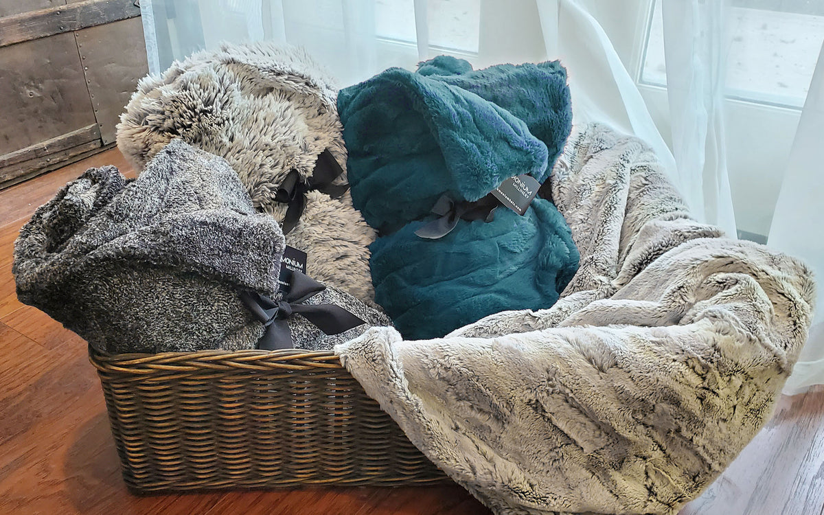 Basket full of assorted faux fur blankets | Pandemonium Millinery