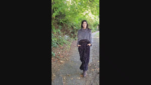 Video of model walking along sidewalk wearing a NW Set. The NW Top in 8MM Black and White and the NW Pants in Cuddly Black. Made by Pandemonium Seattle.