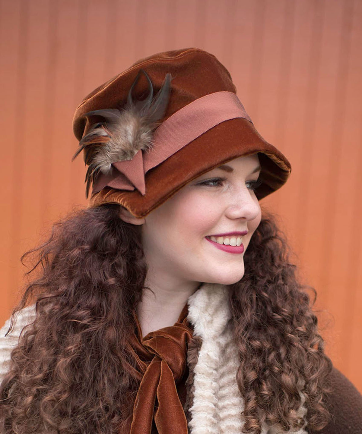 Side view of woman wearing Abigail Hat in Citrine Velvet with Rust Grosgrain Band and Pheasant Feathers| Handmade in Seattle WA| Pandemonium Millinery