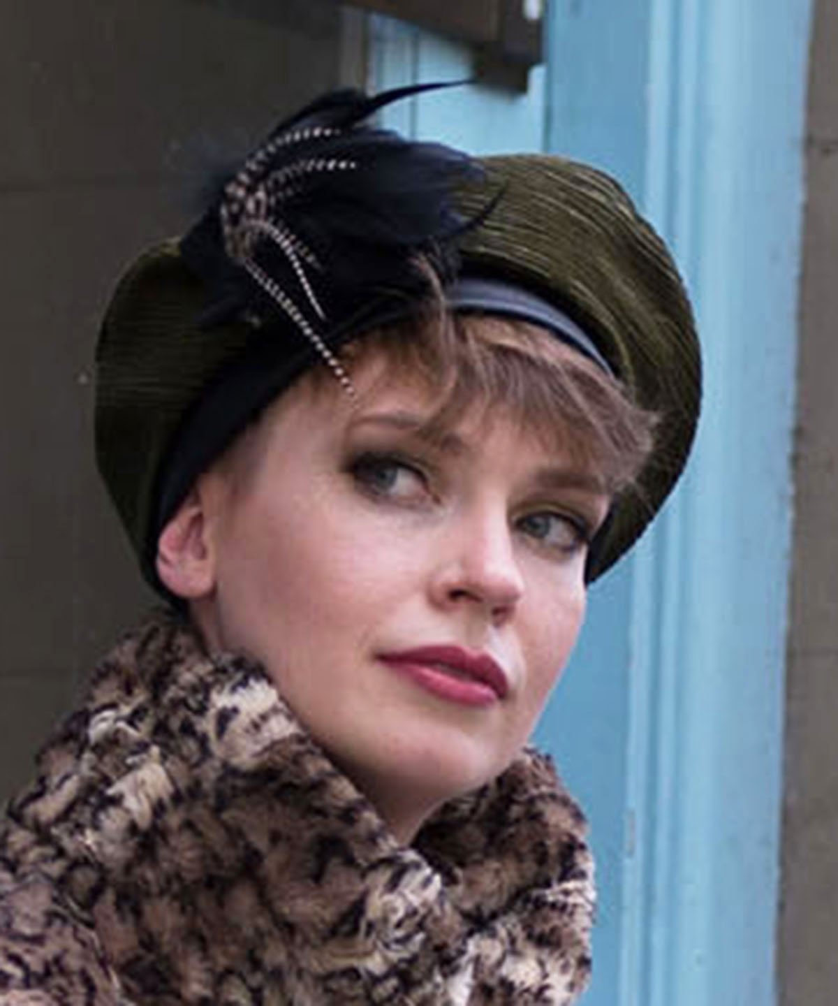 Close up of Model wearing Beret Cohen in Olive with Black Feather Flower Style Brooch | Handsewn in Seattle WA USA | Pandemonium Millinery