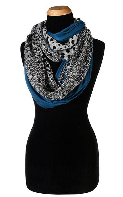 Ladies Two-Tone infinity, Eternity Loop Scarf on Mannequin | Lunar Landing, a black and neutral knit with curled edges surrounding holes, paired with a light-weight light Blue Jersey Knit | Handmade in Seattle WA | Pandemonium Millinery