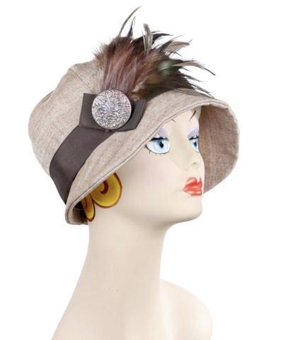 Product Shot of Grace Cloche Style Hat Linen in Coral with Chocolate Grograin Band Featuring a Pheasant Brown Feather Brooch with Hand painted Button | Handmade by Pandemonium Millinery | Seattle WA USA