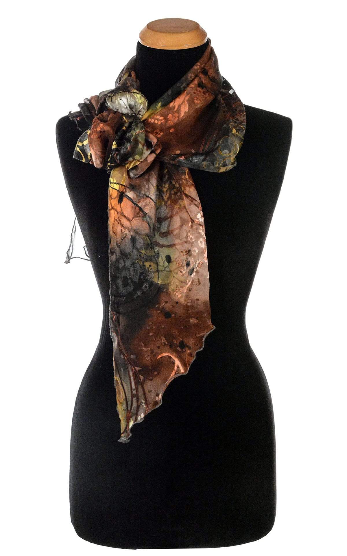 Women’s Large Handkerchief Scarf, Wrap in hand-painted silk on a mannequin shown in a bow | Garden Path in Tiger Lily black, green, rust, yellow, and Gray | Handmade in Seattle WA | Pandemonium Millinery