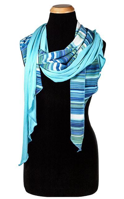 Women’s Large Handkerchief Scarf, Wrap on Mannequin shown  | Shown in Oceans of Emptiness Jersy knit with Sea Breeze rayon a striped pattern on blues, turquoise, greens, and ivory| Handmade in Seattle WA | Pandemonium Millinery