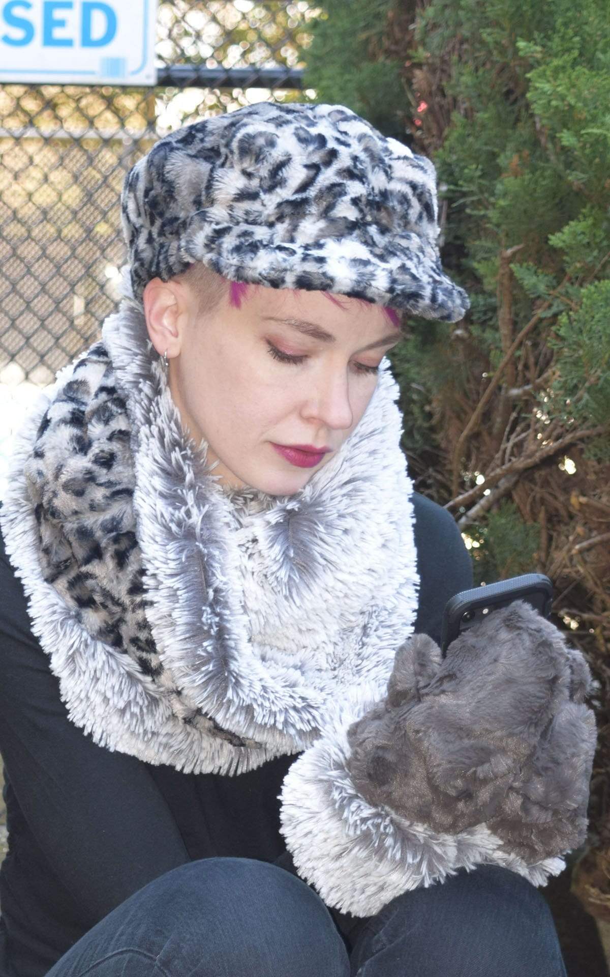 Model wearing Valeri Cap in savannah cat animal print, Scarf and Mittens. Gauntlets, Mitts | Cuddly Gray with Pearl Fox Cuff in Faux Fur | Handmade by Pandemonium Millinery Seattle, WA USA