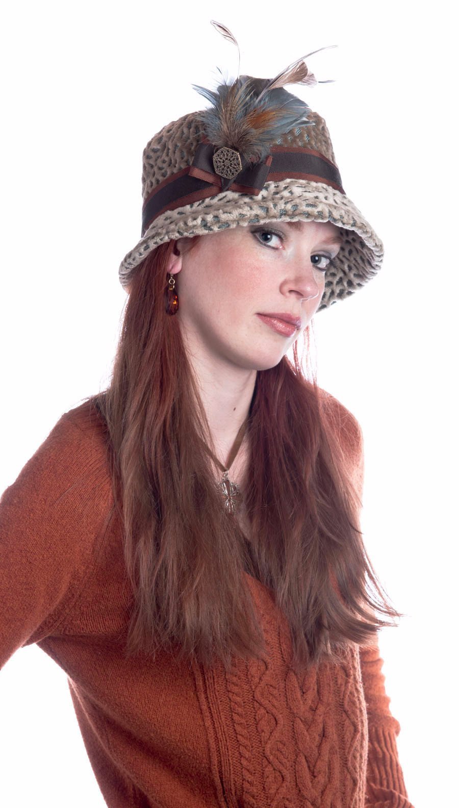 Model wearing Samantha Hat in Rossini Upholstery Fabric | Rust and Chocolate Band with Steel Pheasant Feather Brooch with Hexagon Metal Button | Handmade By Pandemonium Millinery | Seattle WA