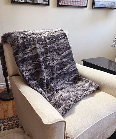 Blanket  on Cream Chair in Muddy Waters; Black Brown and Gray | Luxury Faux Fur Throws | Handmade by Pandemonium Millinery