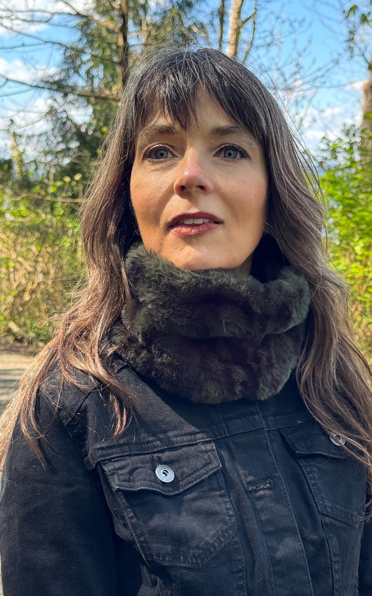 A woman wearing a Royal Opulence Ear/Neck Cozy Wide in Black Pine Faux Fur. Handcrafted by Pandemonium Millinery in Seattle in Agave