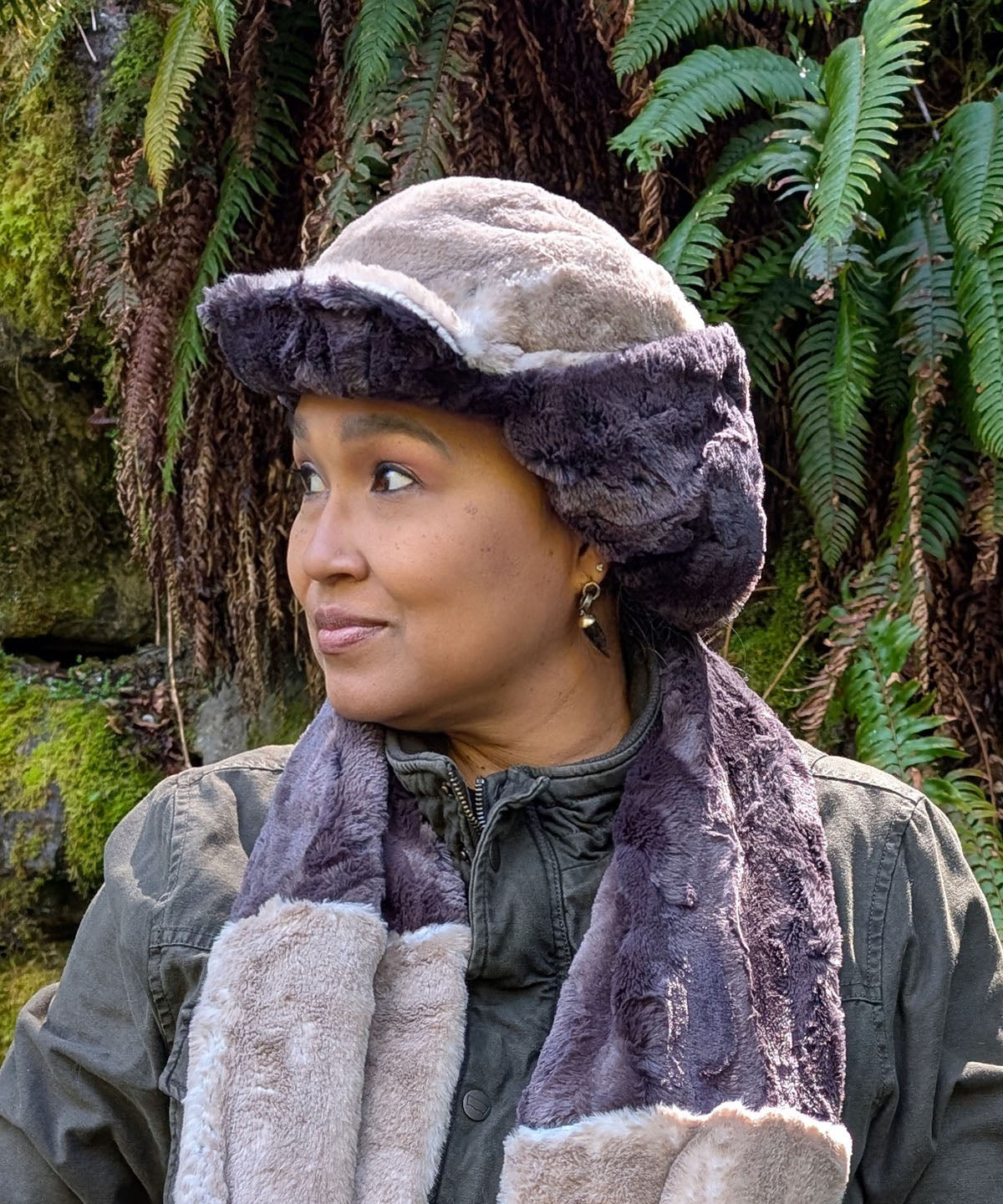 Woman wearing the Aviator Hat in Coastal Plush Golden Bluff lined with Espresso Bean Faux Fur. Shown with the ear flaps buckled up and in profile. Made in Seattle, WA, USA by Pandemonium Seattle.