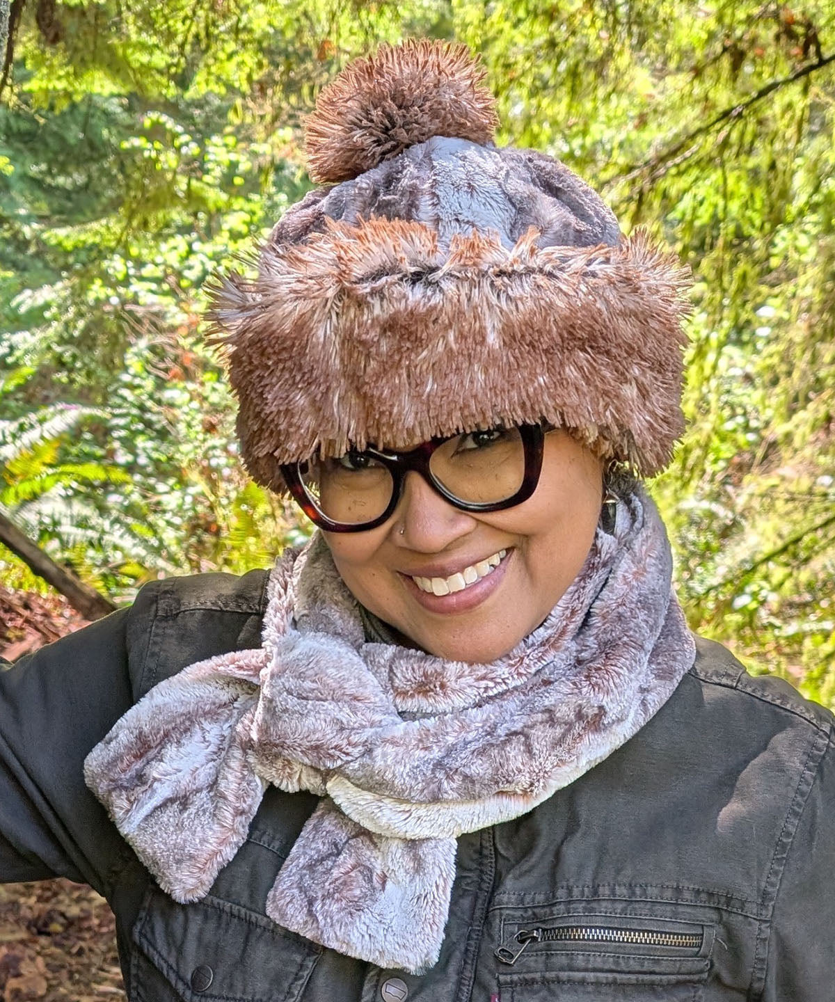 Woman wearing the reversible Beanie in Rusty Rock Faux Fur and Red Fox Faux Fur with a Red Fox Pom and the Skinny Scarf in Rusty Rock. Made in Seattle, WA, USA by Pandemonium Seattle.