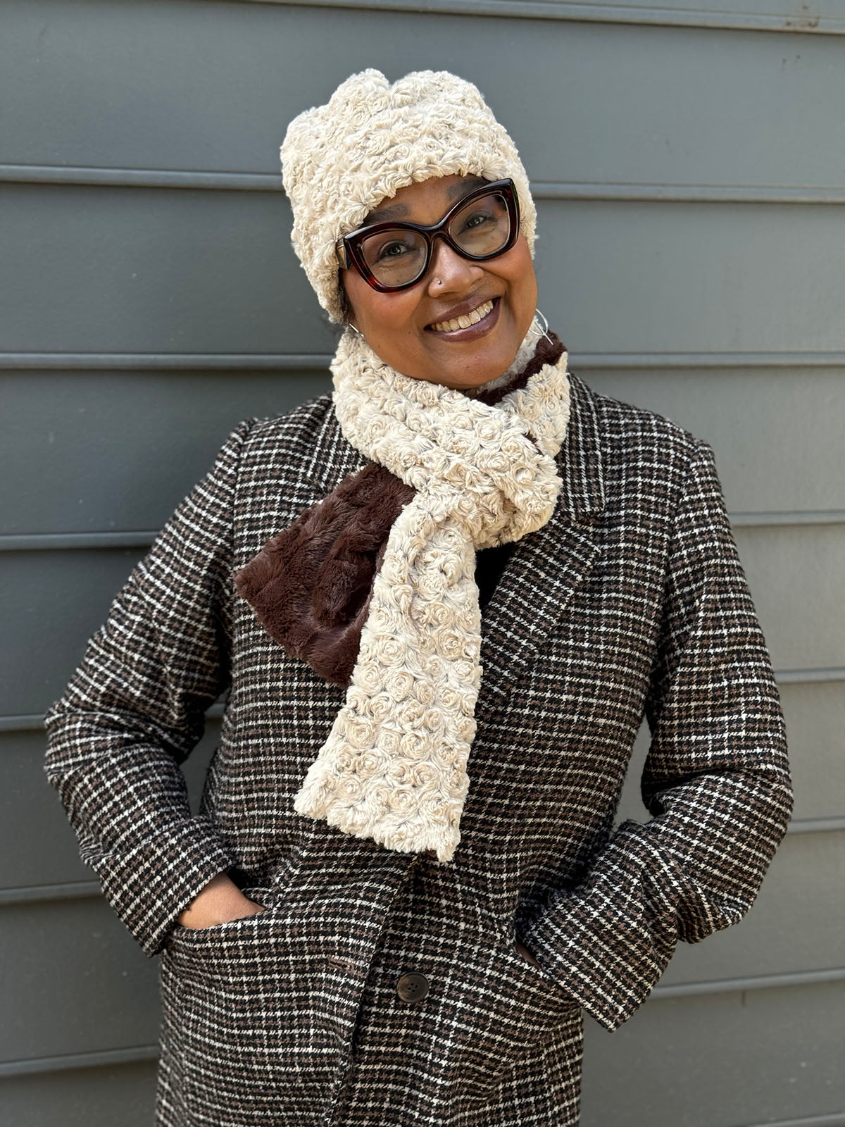 Woman wearing the Classic Two-Tone Scarf in Rosebud Brown and Cuddly Chocolate, and wearing the matching Beanie Hat in Rosebud Brown. Made in Seattle, WA, USA by Pandemonium Seattle.