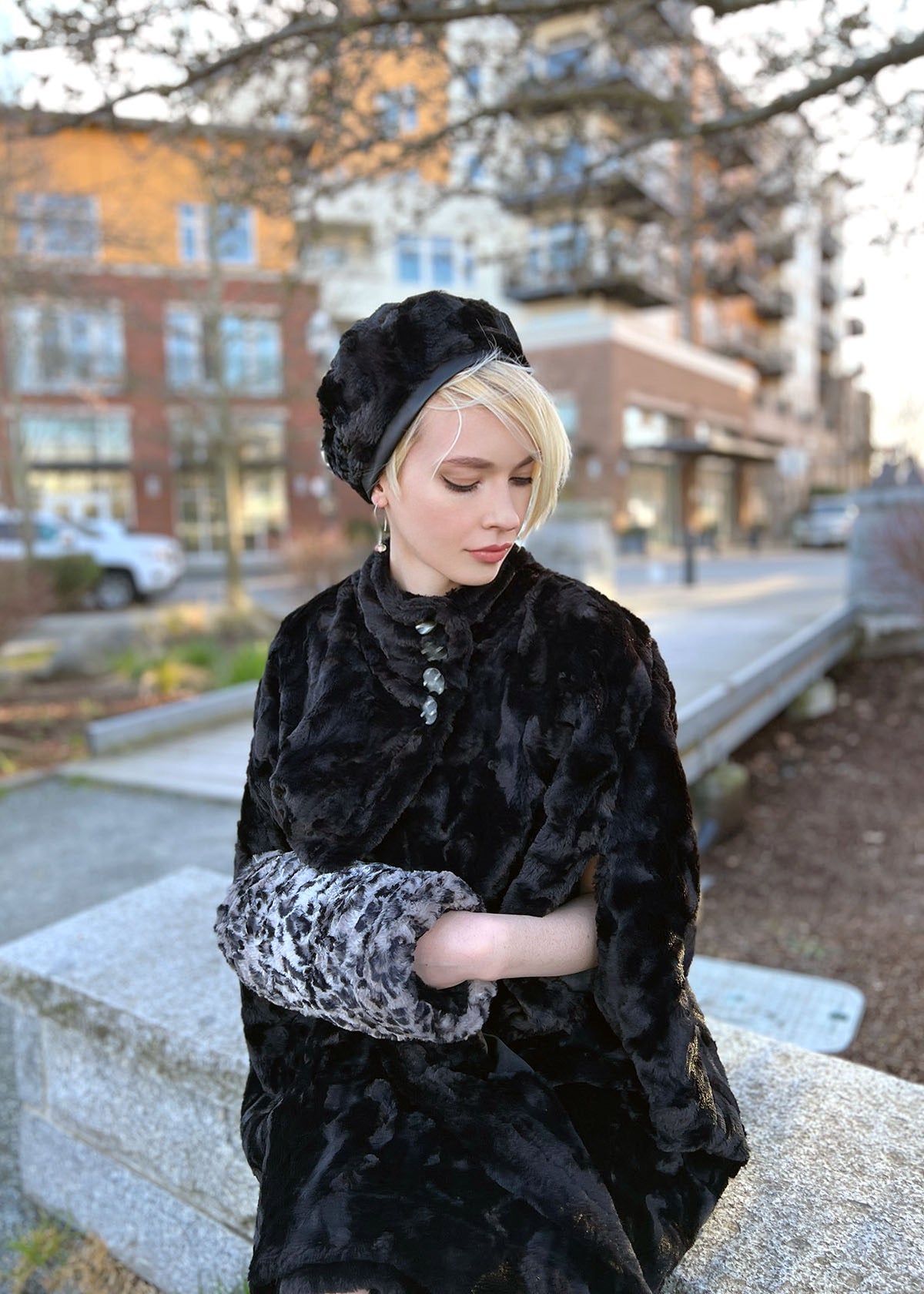 Woman keeping hands warm inside a Muff in Savannah Cat Faux Fur Reversible | Handmade in Seattle WA | Pandemonium Millinery