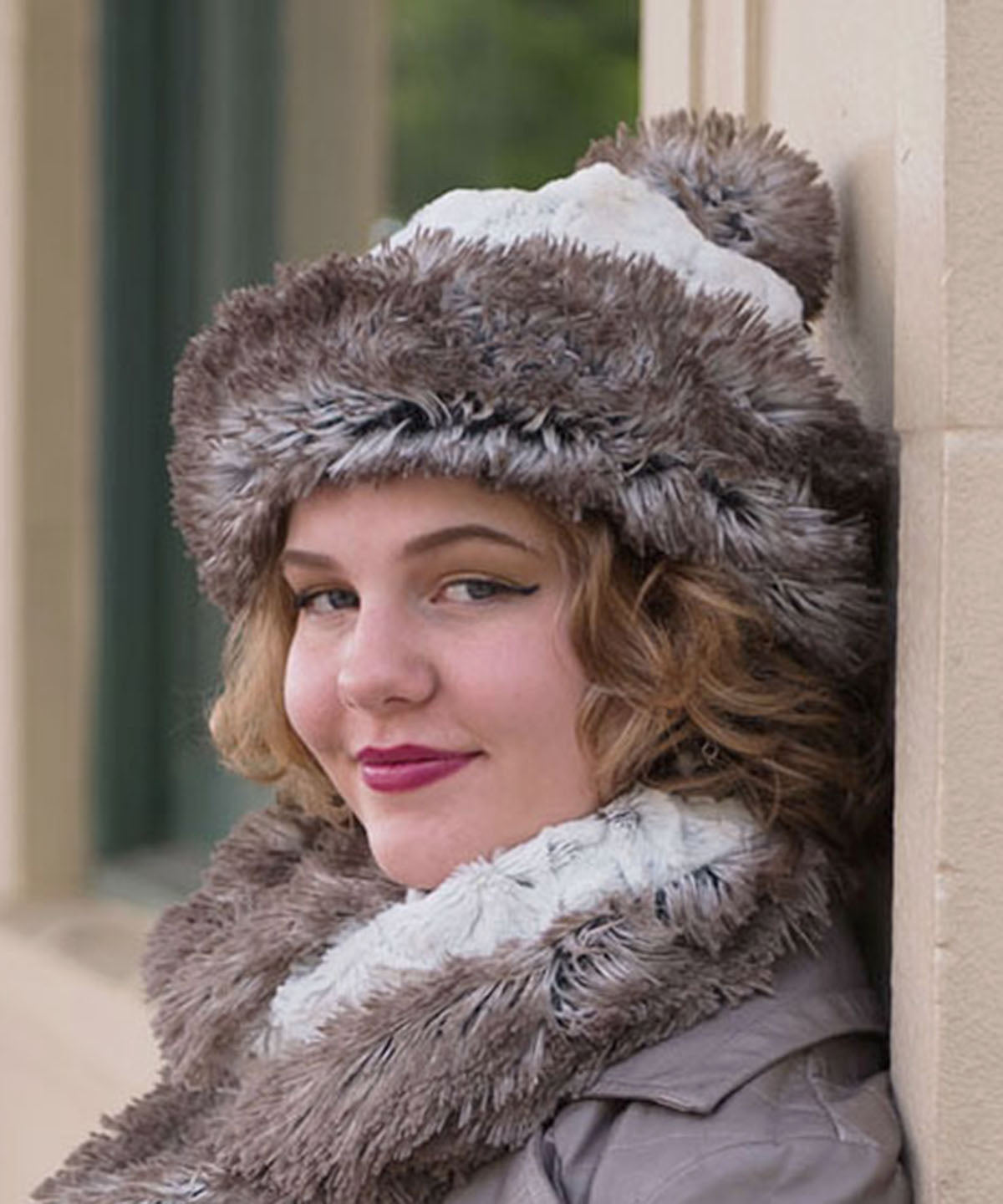 Woman wearing Beanie Hat with Pom shown in reverse in Arctic Fox and Winters Frost Faux Fur. Handmade by Pandemonium Millinery in Seattle, WA.