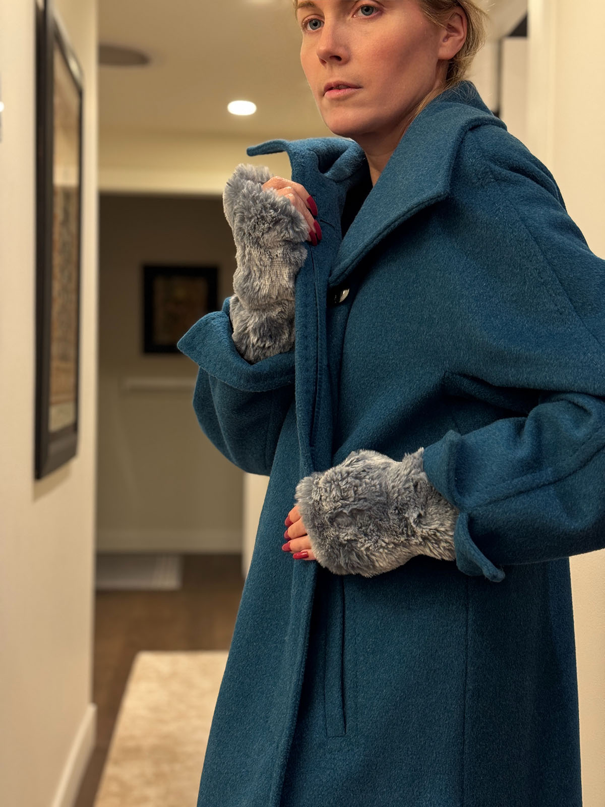 Woman wearing Cloudwalk Blue Mist Fingerless Gloves and wearing a coat. Made in Seattle, WA, USA by Pandemonium Seattle.