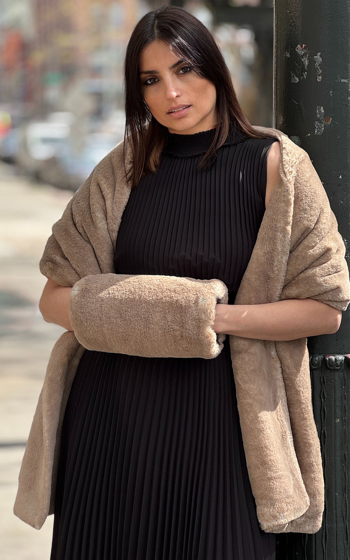Woman standing by Pole in black dress featuring a Stole in Golden Bluff Faux Fur with a matching handmuff.  Handmade in Seattle, WA, USA