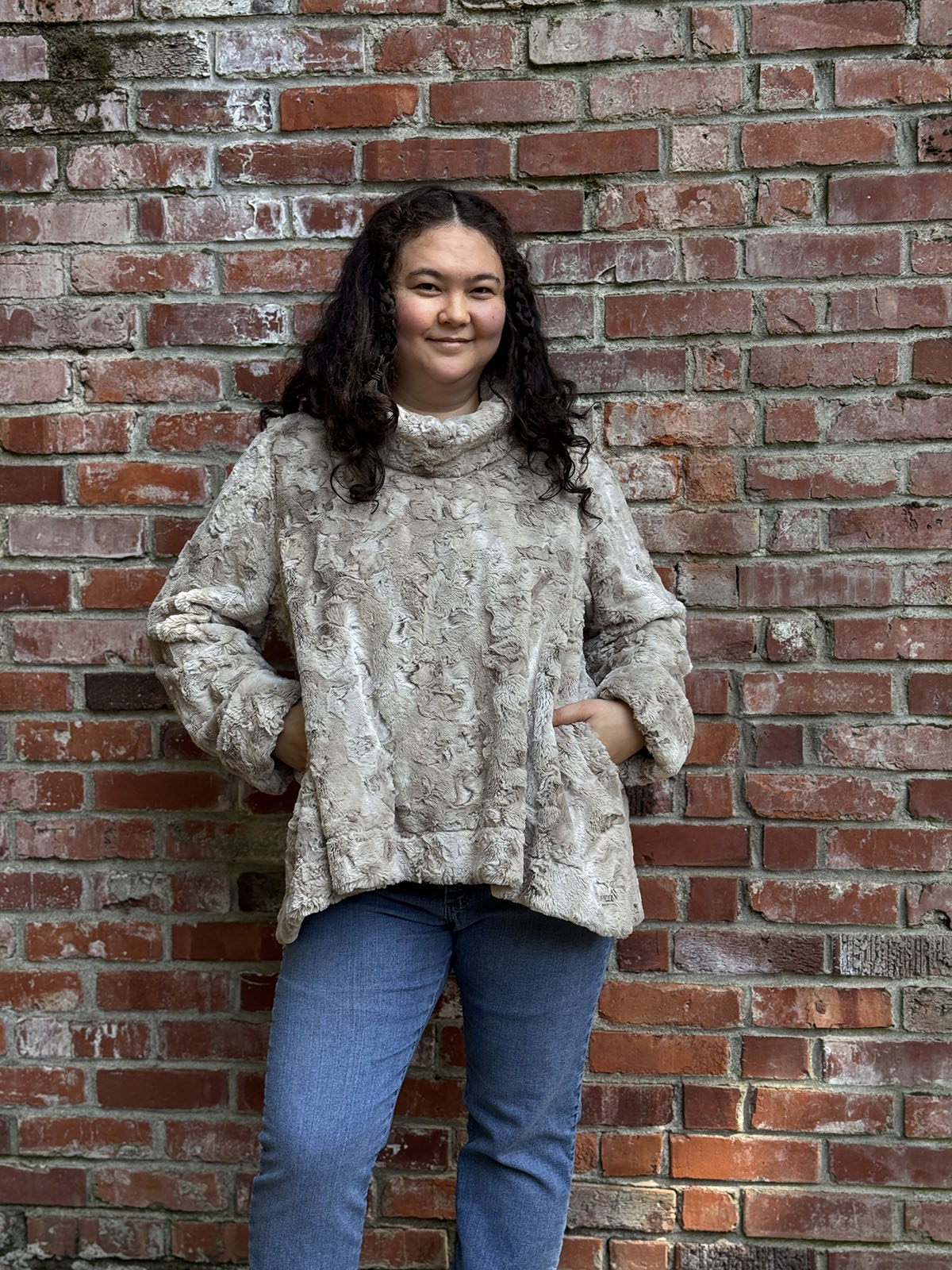 Woman wearing the Cowl Top Pullover in Cafe Au Lait with hands in pockets. Hand sewn in Seattle, Washington by Pandemonium Seattle.