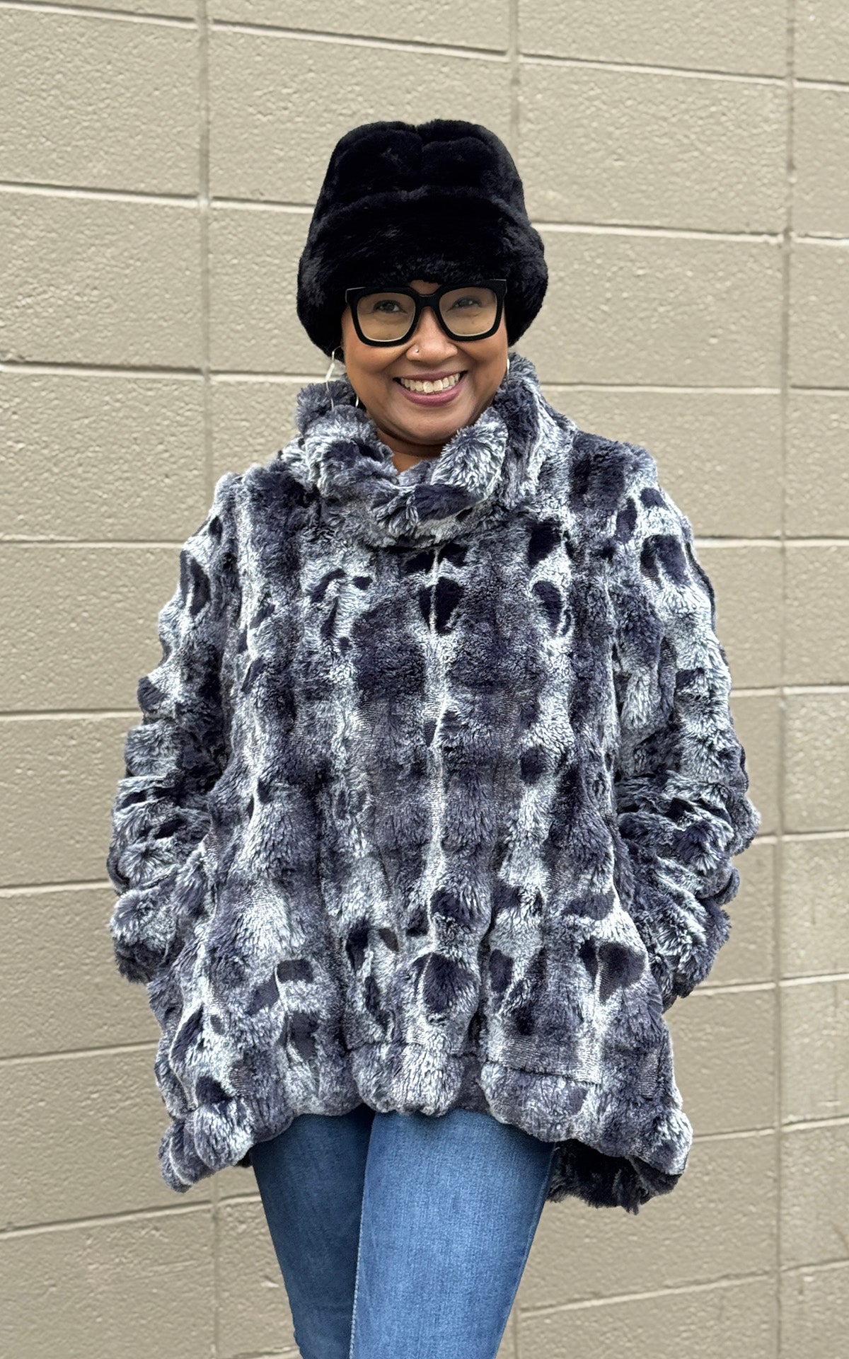 Woman wearing the Cowl Top Pullover in Cloudwalk in Shadow with a Royal Opulence Beanie in Onyx. Made in Seattle, WA, USA by Pandemonium Seattle.