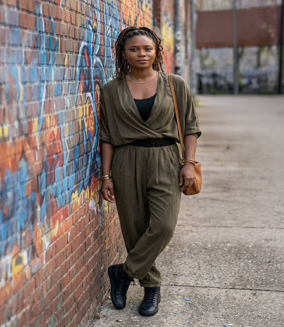 A woman wearing the Pleated Ankle Jogger Pants in Dusk Olive Green with the matching Crossover Top. Made in Seattle, WA, USA by Pandemonium Seattle.