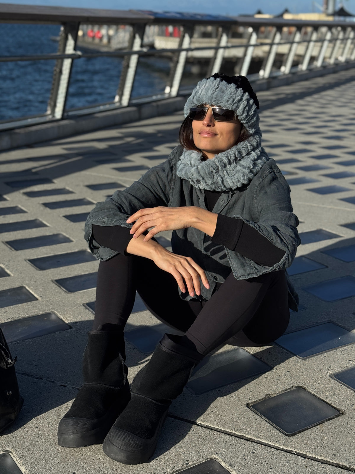 Woman wearing a Cuffed Pillbox and Neck Warmer in Cirrus Blue Mist. Handmade in Seattle, WA, USA by Pandemonium Millinery.