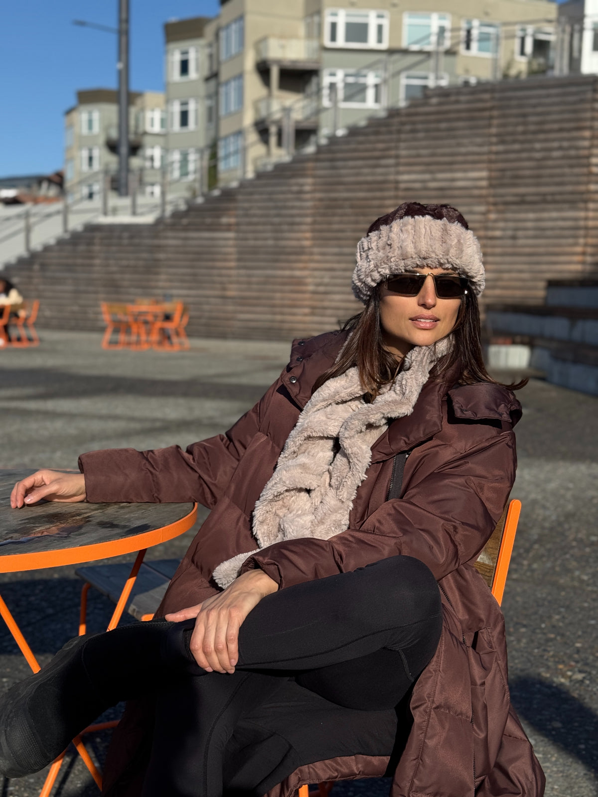 Woman wearing a Cuffed Pillbox in Cirrus Honey with Chocolate and a Scrunchy Scarf in Cirrus Honey. Handmade in Seattle, WA, USA by Pandemonium Millinery.