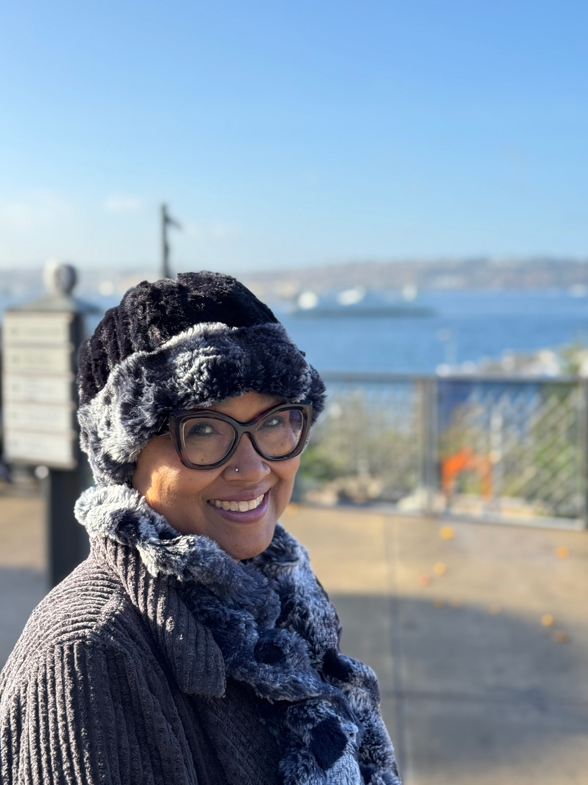 Woman wearing the Cuffed Pillbox in Cloudwalk Shadow with CIrrus Shadow, shown reversed to Cirrus Shadow with Cloudwalk cuffed. Handmade in Seattle, WA, USA by Pandemonium Millinery.