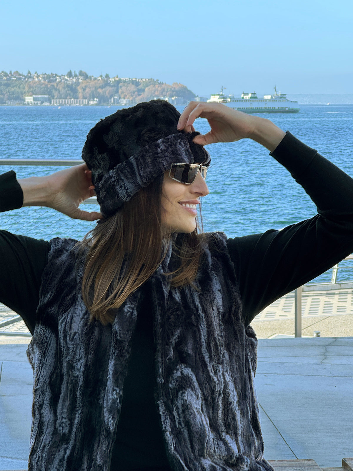 Woman wearing a Cuffed Pillbox in Black Marble and Cuddly Black. Worn reversed to show Black Marble as cuff color. Handmade in Seattle, WA, USA by Pandemonium Millinery.