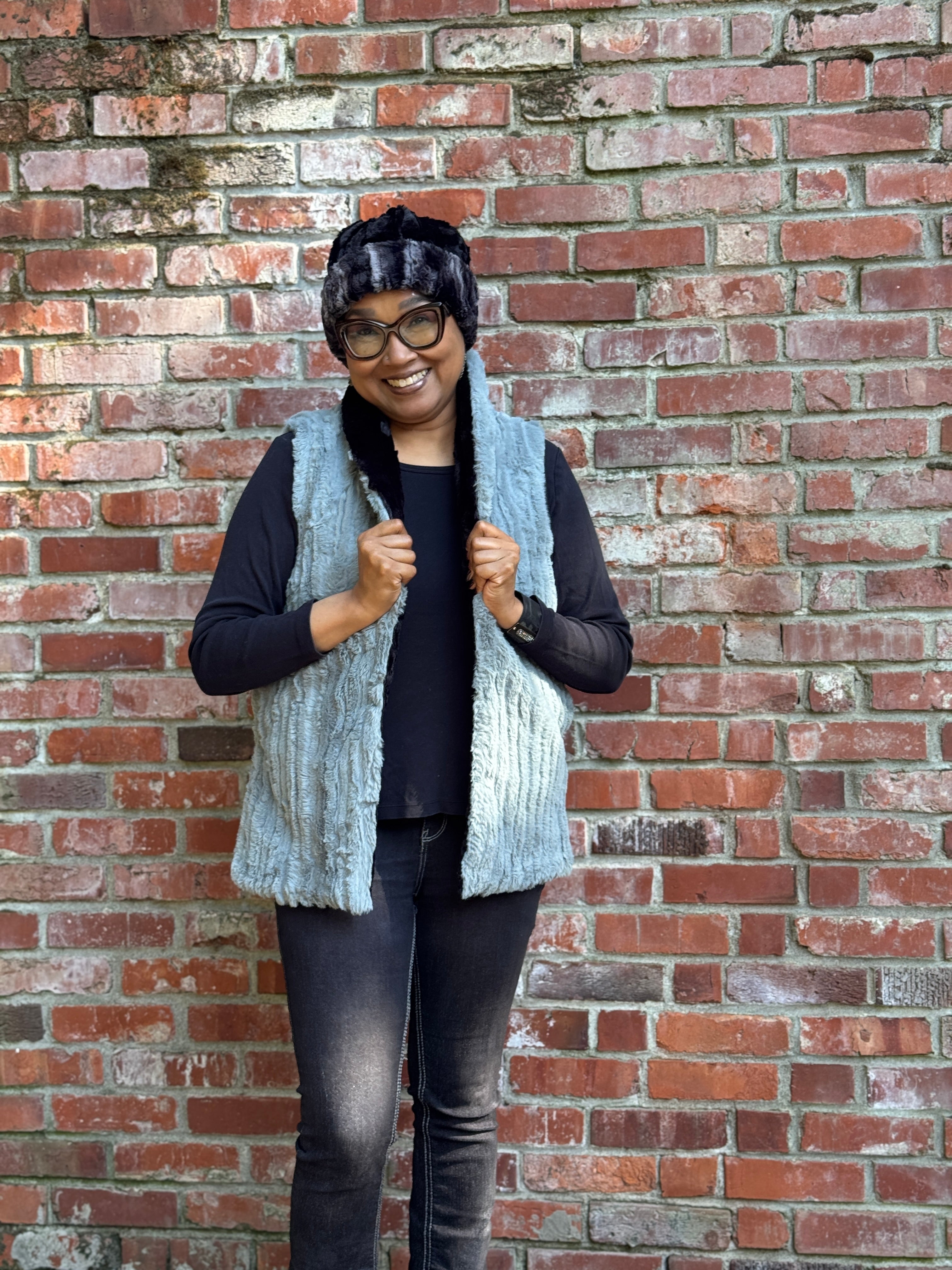 Woman wearing the Shawl Collar Vest in Cirrus Blue Mist with reversible Cuddly Black faux fur. Hand sewn in Seattle, Washington by Pandemonium Seattle.

