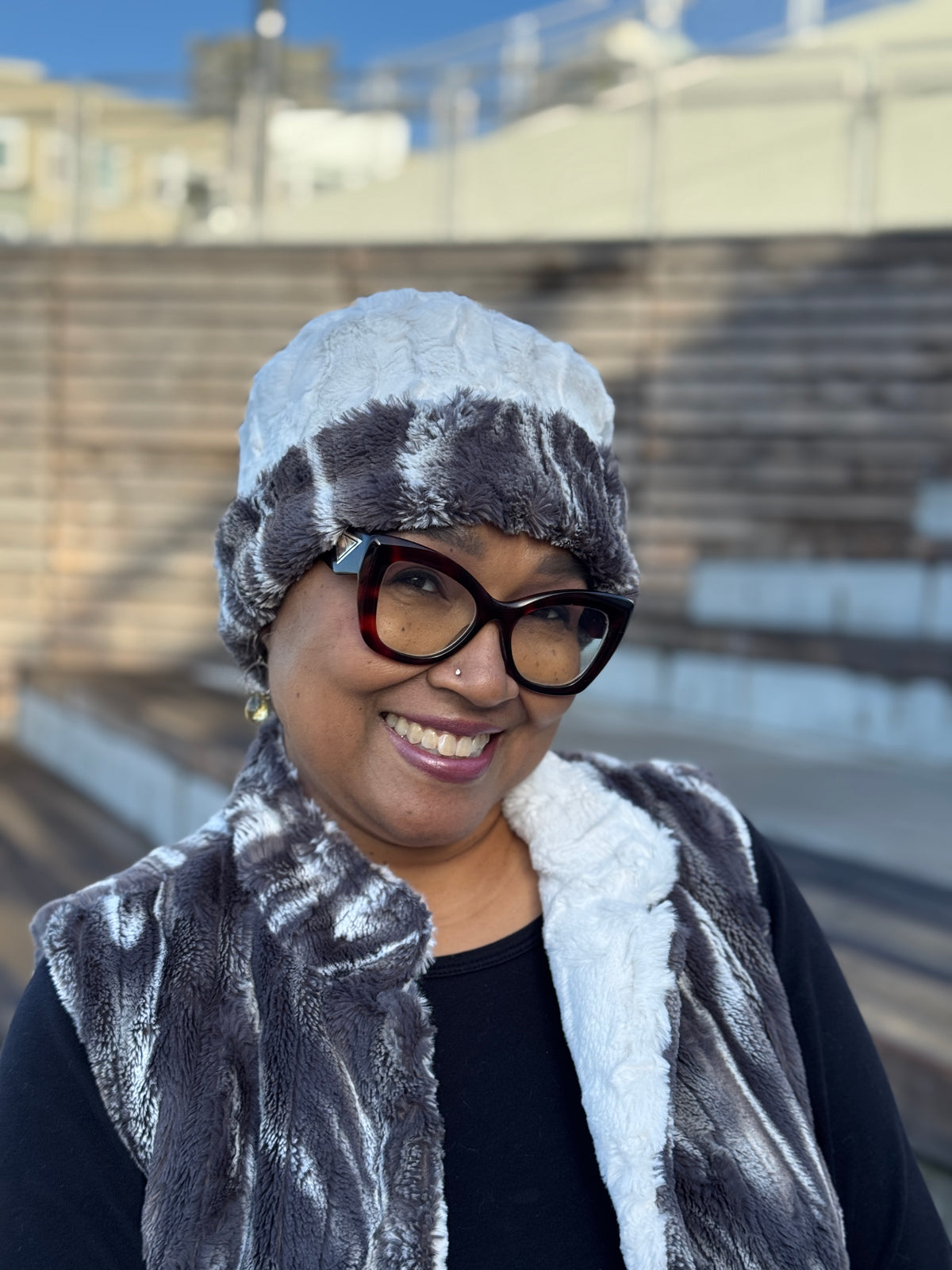 Woman wearing a Cuffed Pillbox in Grey Marble and Cuddly Ivory. Worn reversed to show Black Marble as cuff color. Handmade in Seattle, WA, USA by Pandemonium Millinery.