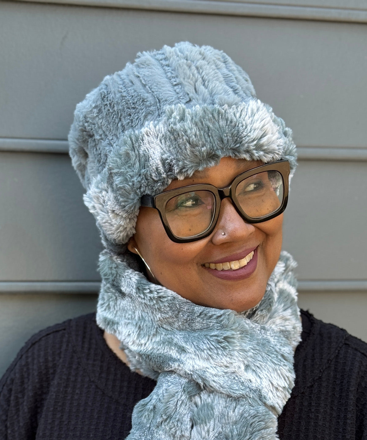 Woman wearing a Cuffed Pillbox in Cloudwalk Blue Mist with reversible Cirrus Blue Mist. Brim rolled up to display both fabrics. Hand sewn in Seattle, WA by Pandemonium Seattle.

