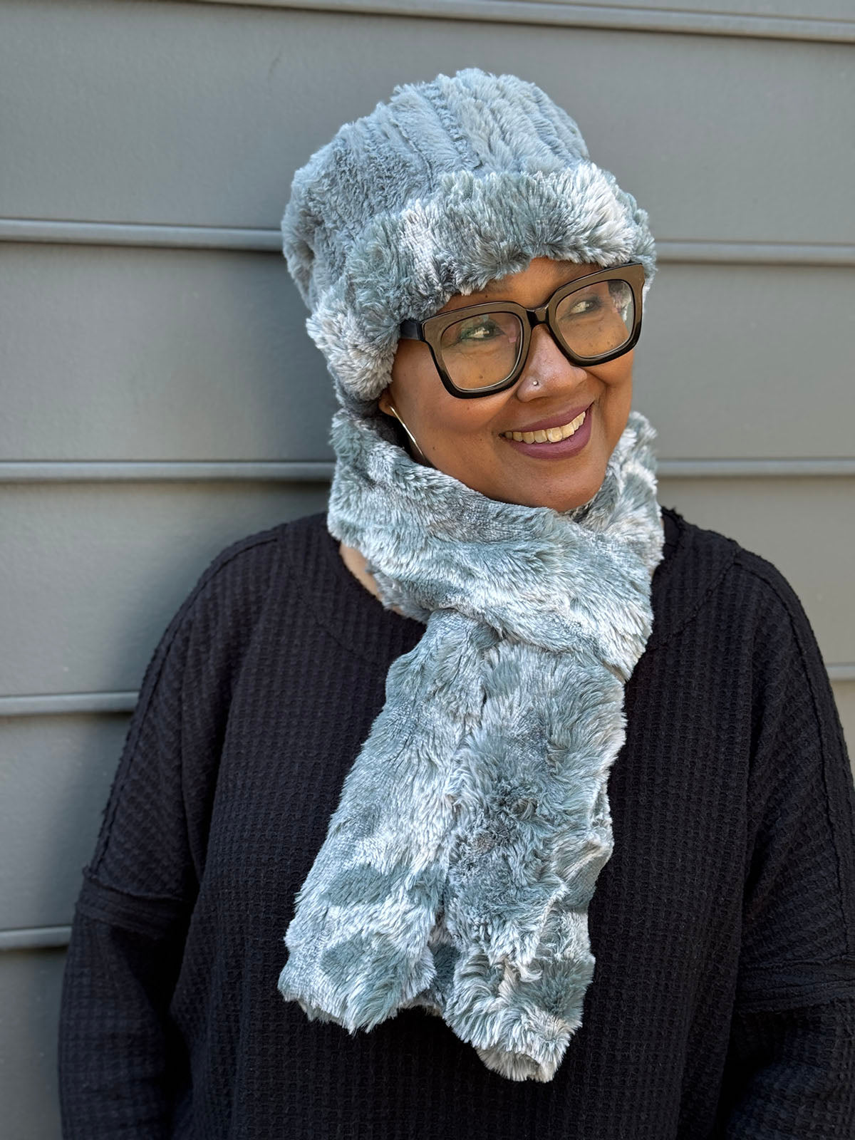 Woman wearing a Classic Scarf in Cloudwalk Blue Mist, shown with Cuffed Pillbox in Cloudwalk Blue Mist and Cirrus Blue Mist reversed to show Cirrus side. Hand sewn in Seattle, WA by Pandemonium Seattle.