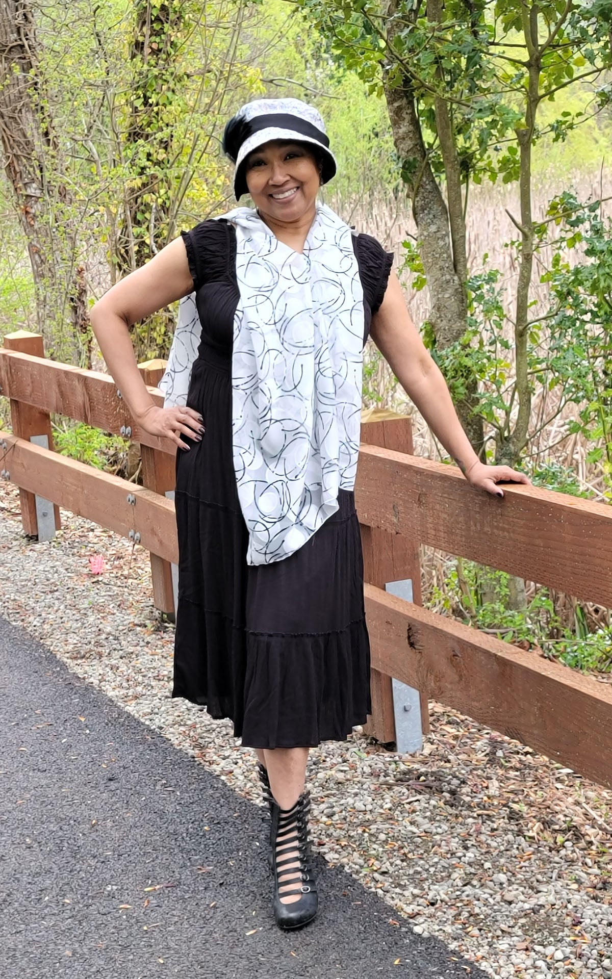 Woman wearing the Lumina Poncho in Ditzy Dame, shown styled as a scarf. Made in Seattle, WA, USA by Pandemonium Seattle.