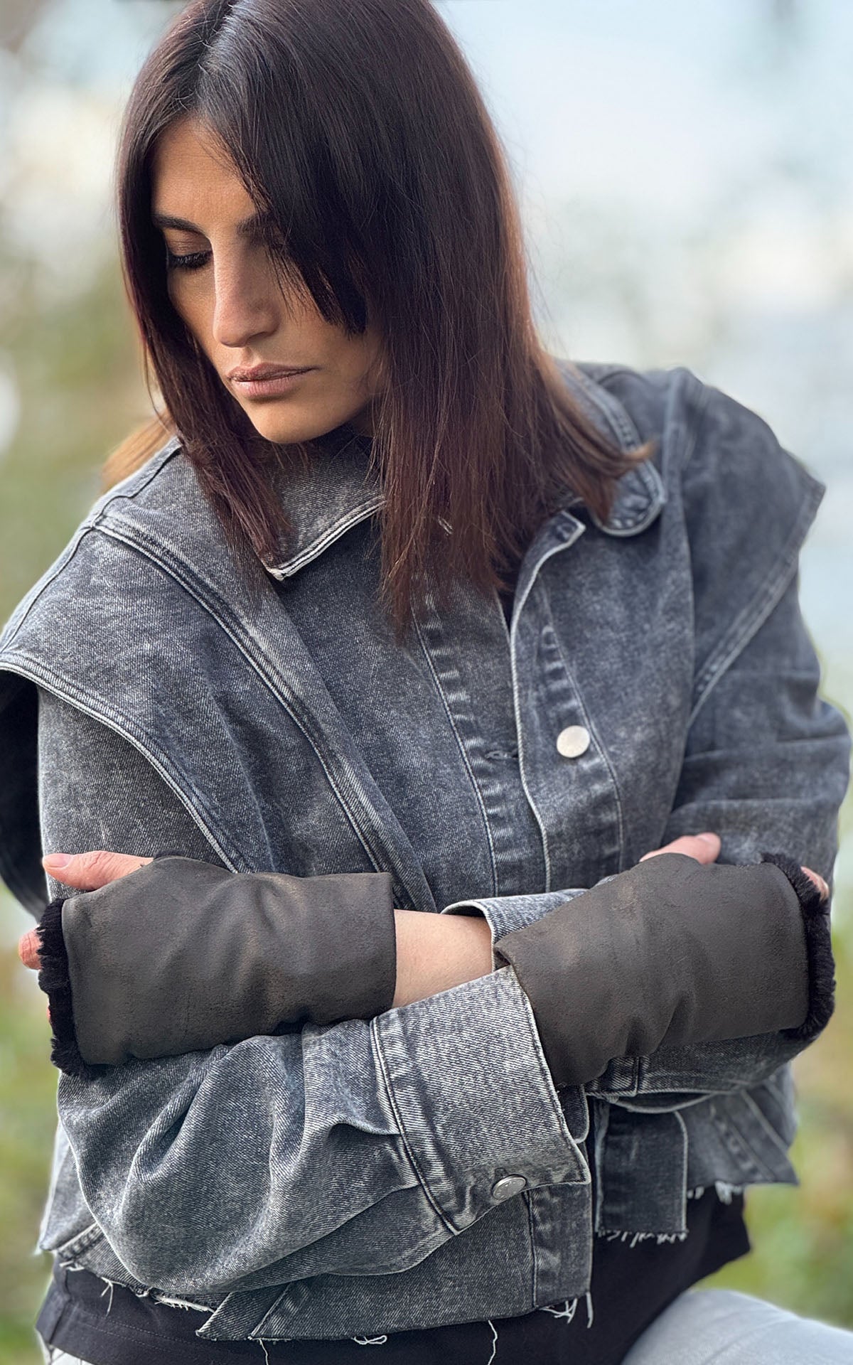 Model with arms crossed featuring Fingerless Gloves in Vegan Rustic Leather in Olive with short hair Luxury Faux Fur lining. Handsewn in Seattle, WA, USA by Pandemonium Seattle.