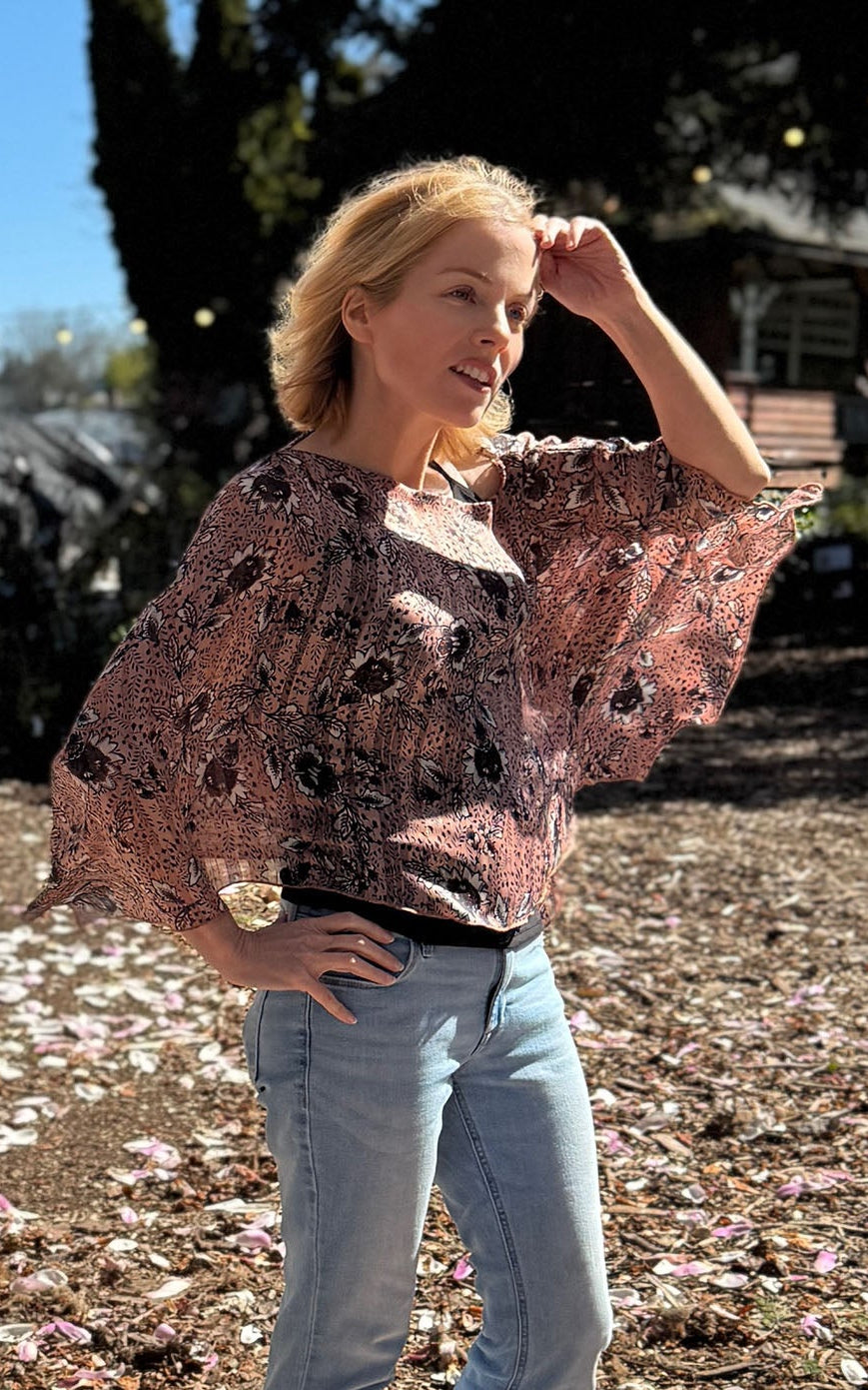 Woman wearing the Lumina Poncho in Hippy Chick. Made in Seattle, WA, USA by Pandemonium Seattle.
