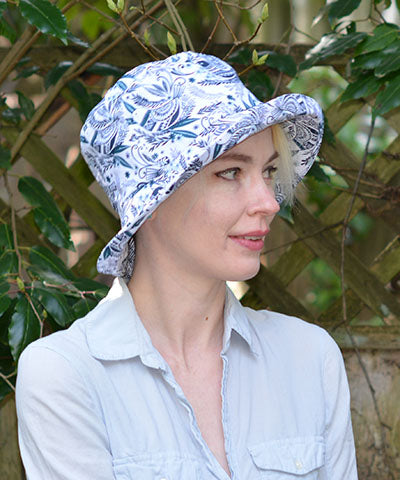 Side shot of model in Hollie Bucket Hat in Festive Birds Black and Blue. Pandemonium is Handmade in America.