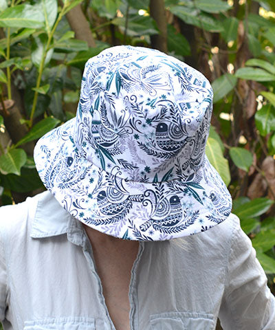 Crown shot of Model in Hollie Bucket Hat in Festive Birds Black and Blue. Pandemonium is Handmade in America.