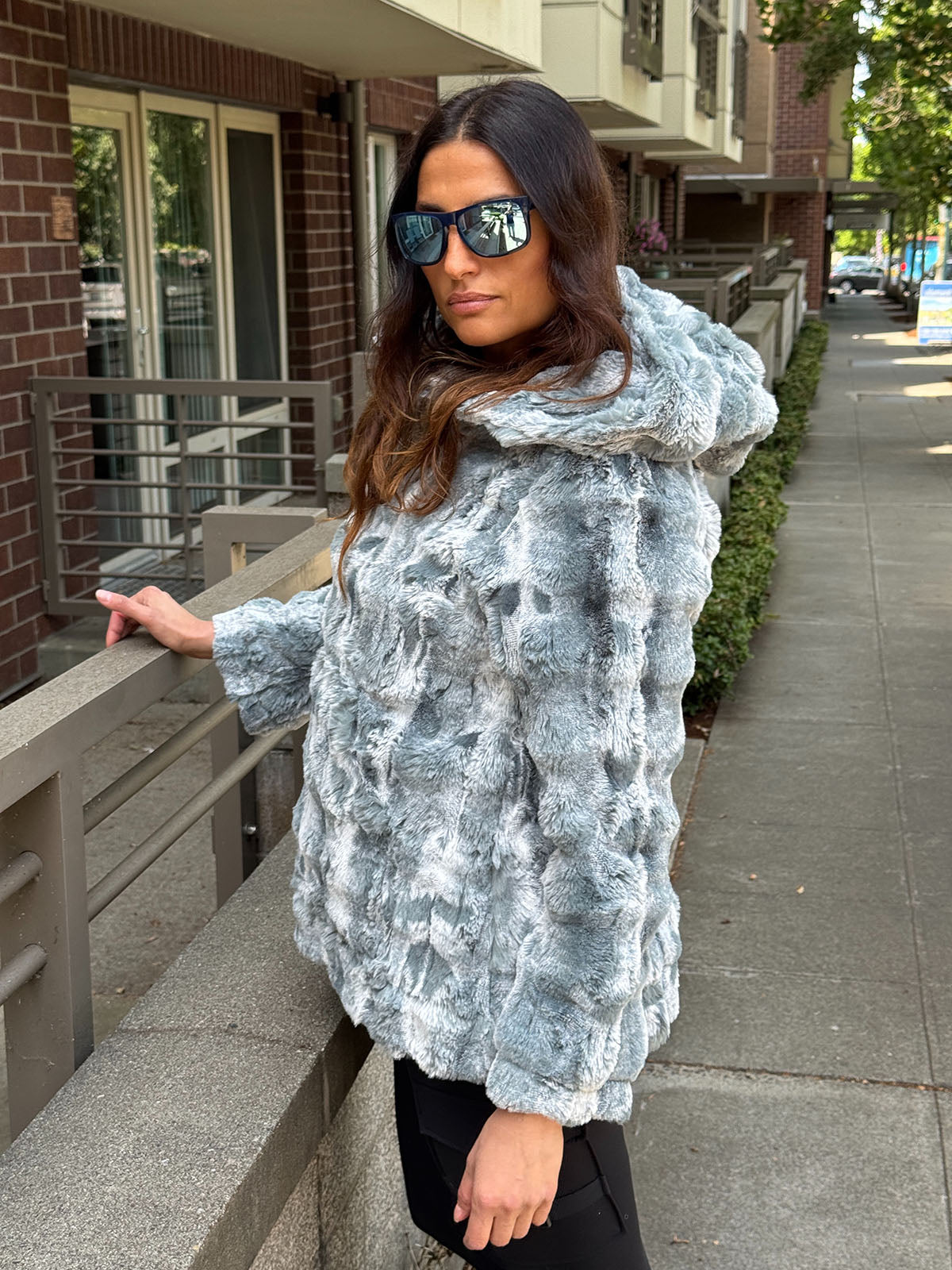 Woman wearing the Hooded Lounger in Cloudwalk Blue Mist with the hood down. Hand sewn in Seattle, WA by Pandemonium Seattle.