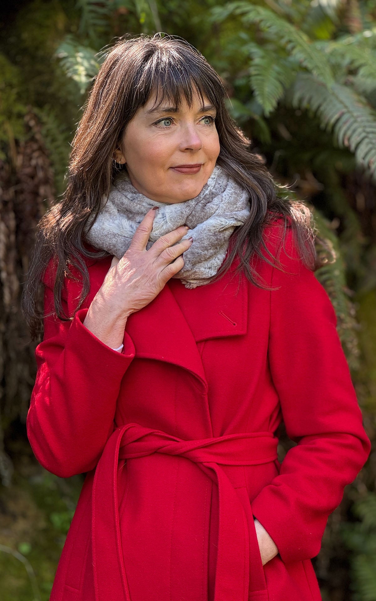 A woman wearing the Infinity Scarf in Driftwood Faux Fur. Its worn like cowl styled wrap around the neck. Handsewn by Pandemonium Seattle, WA USA 