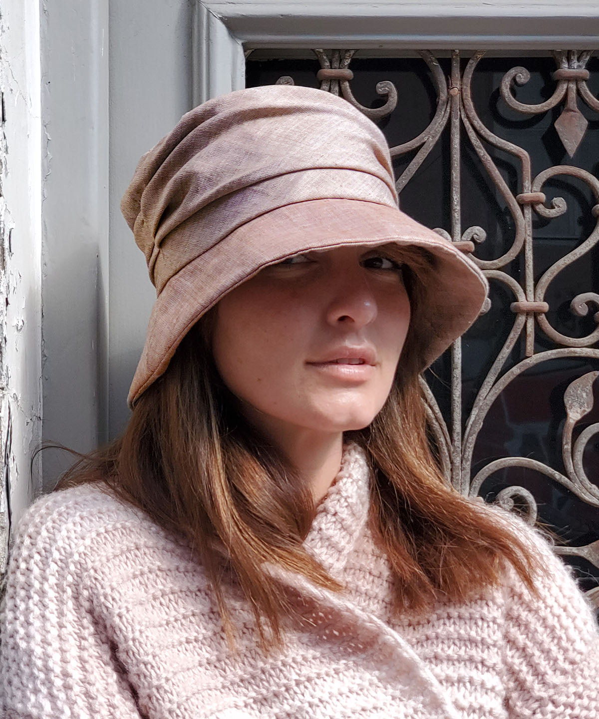Model wearing a Krystyn Style hat in Coral Linen | Handmade in Seattle | Pandemonium Millinery
