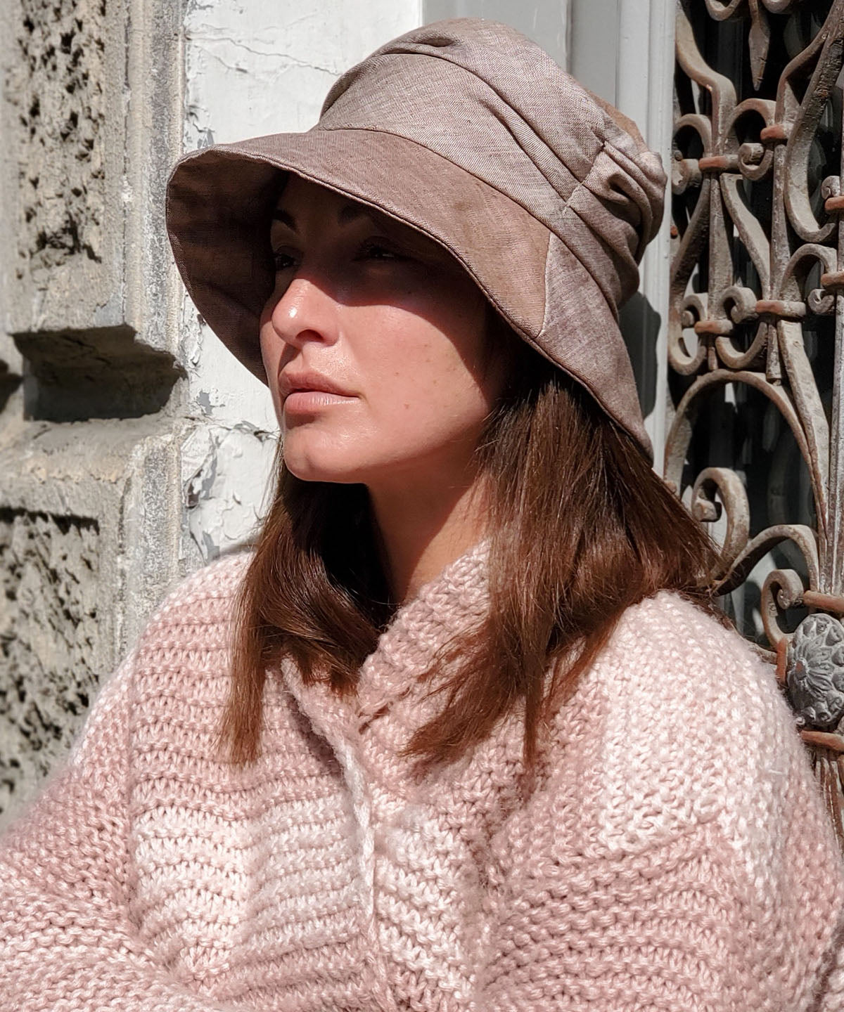 Model wearing a Krystyn Style hat in Coral Linen - Side View | Handmade in Seattle | Pandemonium Millinery