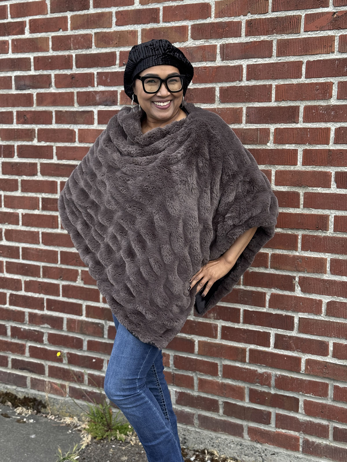 Woman wearing the Royal Opulence Poncho in Mink Grey and smiling. Made in Seattle, WA, USA by Pandemonium Millinery. 