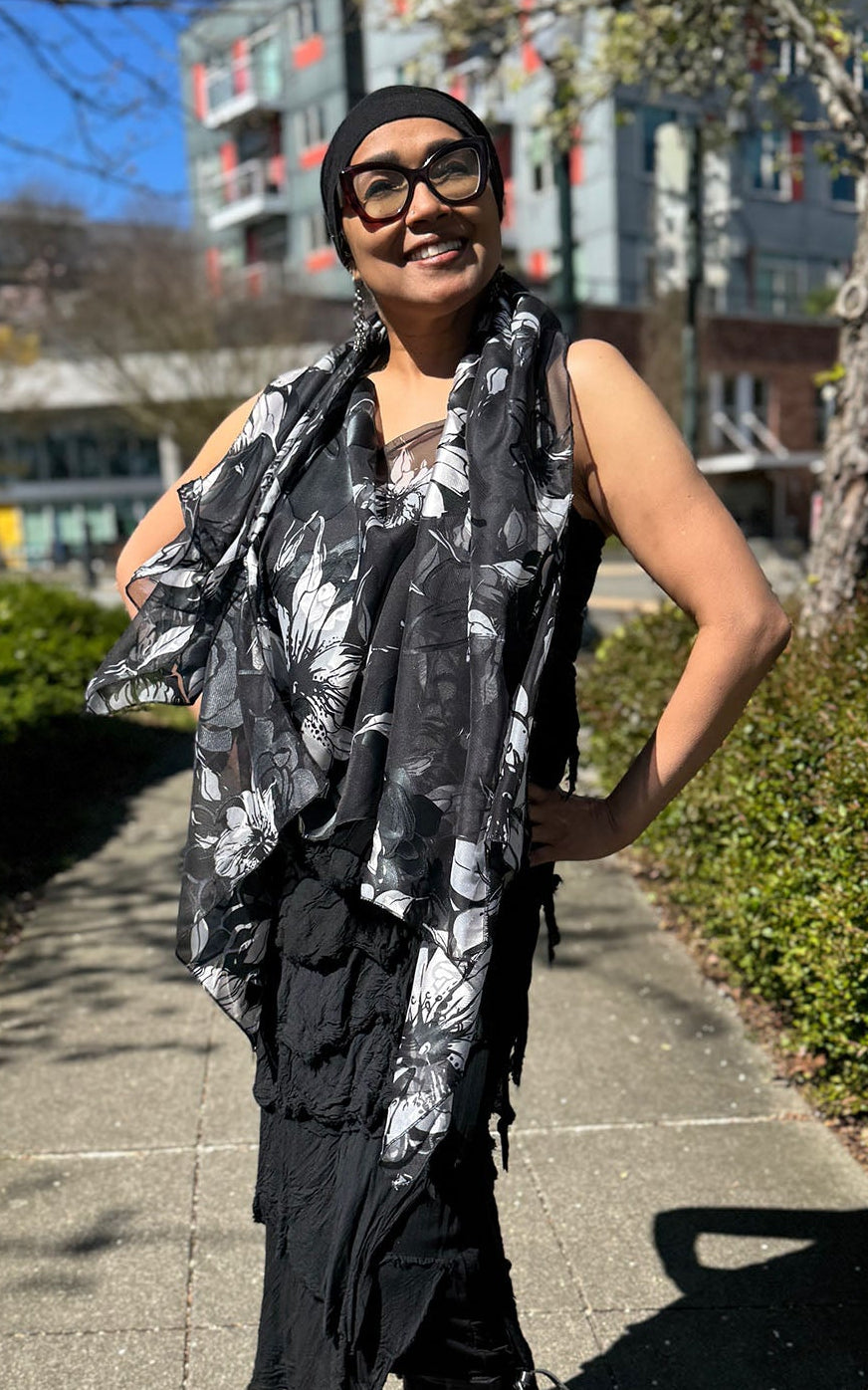 Woman wearing the Lumina Poncho in Leading Lady, shown styled as a scarf. Made in Seattle, WA, USA by Pandemonium Seattle.