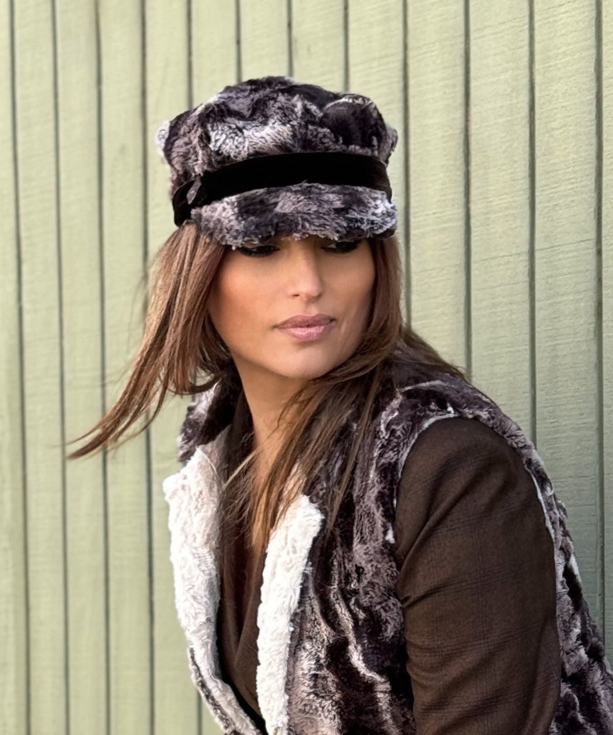 Model against green wall wearing a matching Newsboy Hat and Mandarin Vest - Luxury Faux Fur in Mocha with a Cuddly Sand Lining - Handmade USA by Pandemonium Seattle