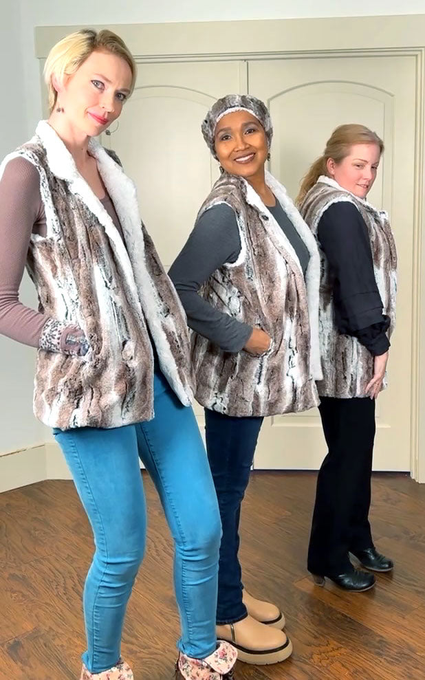 Three women of varying heights wearing matching Short Mandarin Vests in Birch Faux Fur with Cuddly Ivory Faux Fur. Reversible. Custom made by Pandemonium Seattle.