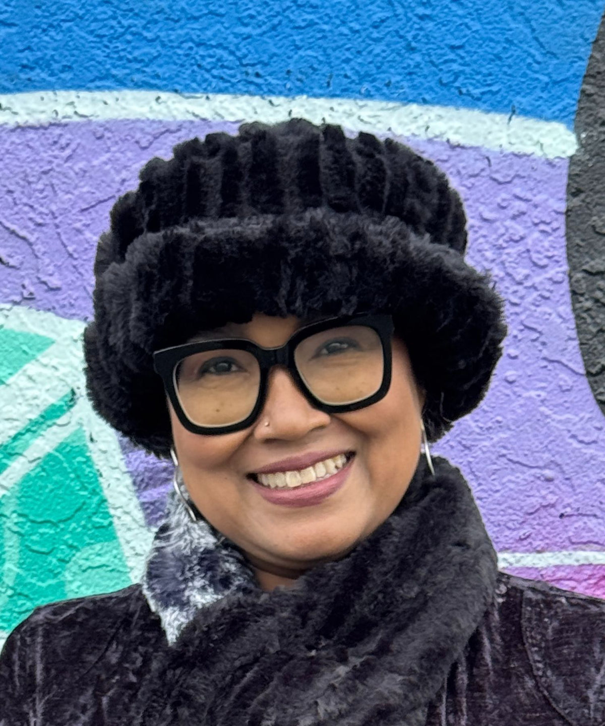 Woman wearing a Molly Hat in Cirrus Shadow, a very plush, black faux fur with a fun brim. Hand sewn in Seattle, Washington by Pandemonium Seattle.