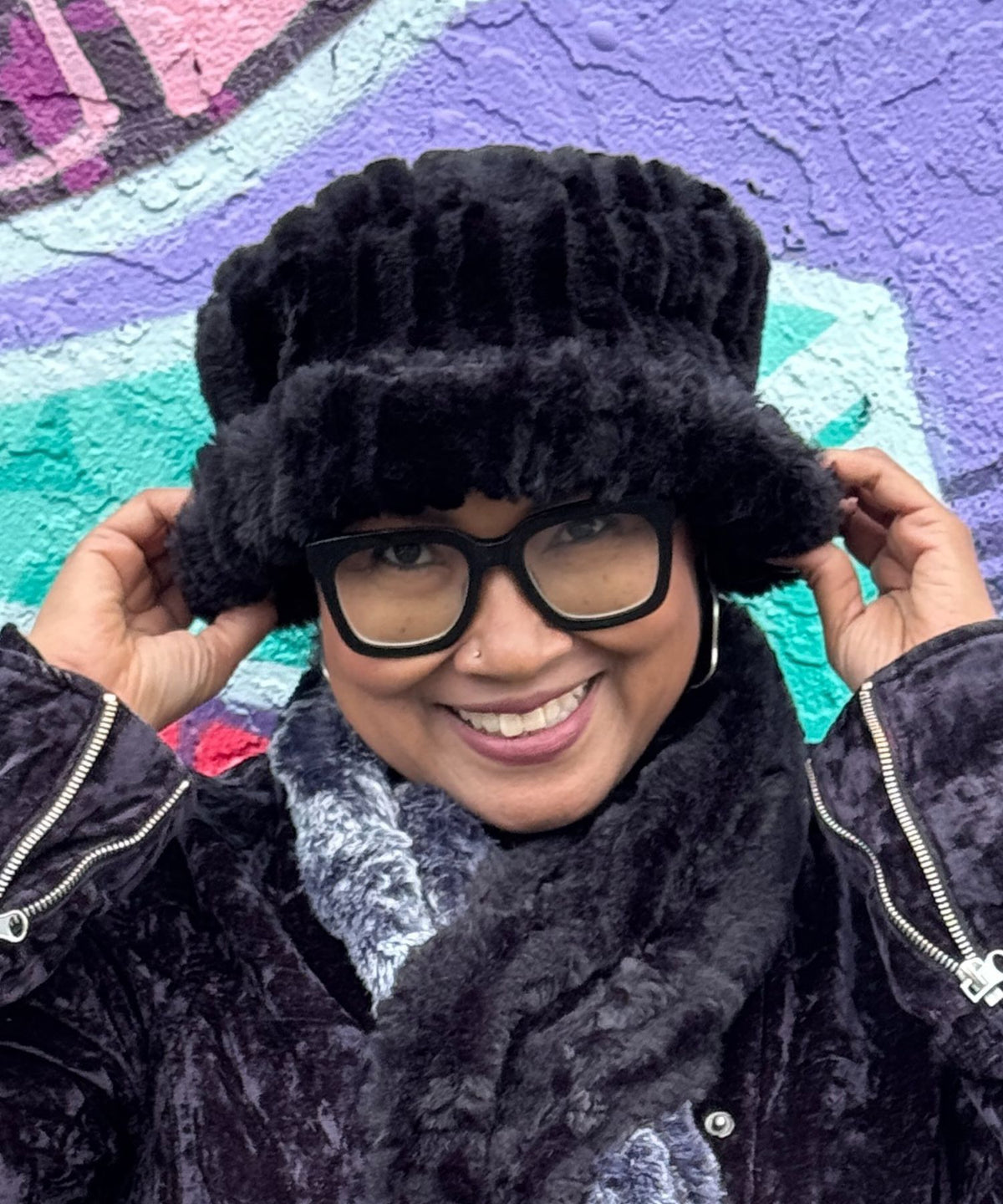 Close up of a woman wearing a Molly Hat in Cirrus Shadow, a very plush, black faux fur with a fun brim. Hand sewn in Seattle, Washington by Pandemonium Seattle.