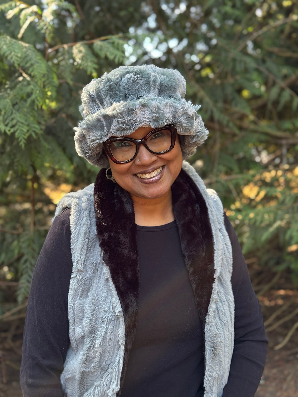 Woman wearing the Molly Hat in Cloudwalk Blue Mist with the brim turned up. The Molly Bucket Hat is hand sewn in Seattle, Washington by Pandemonium Seattle.