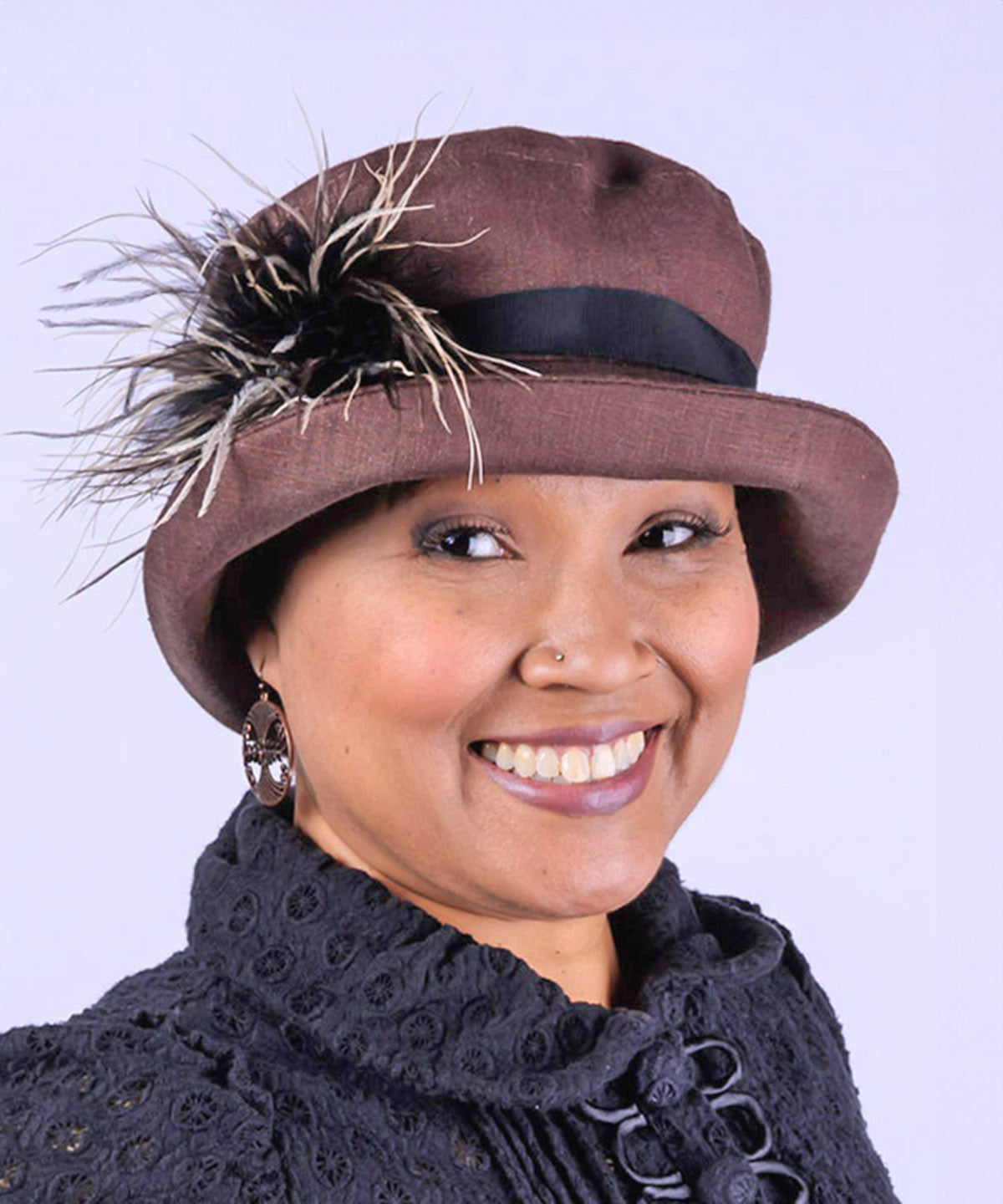 Woman wearing Molly Bucket Style Hat in Chocolate Linen with Black Band with Chocolate, Cream and Black Ostrich Brooch | Handmade By Pandemonium Millinery in Seattle WA