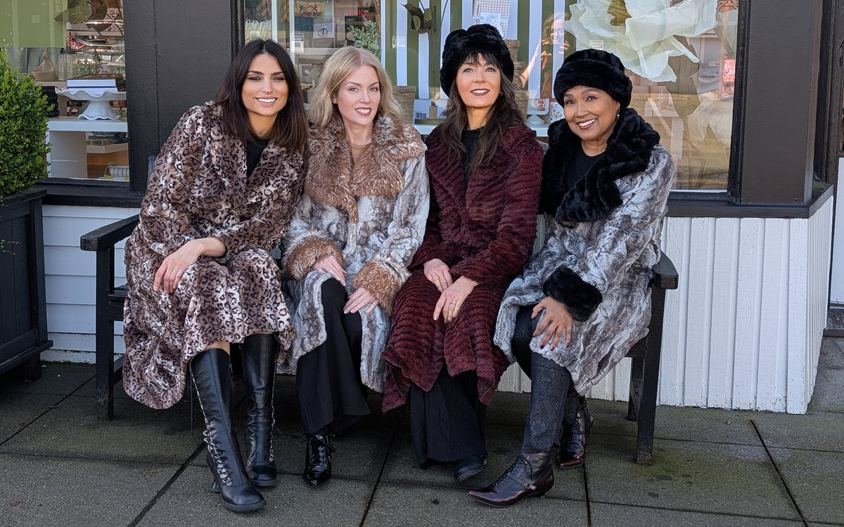 A group of four woman sitting on a bench wearing Hayworth and Roxy Faux Fur Coats.  Handmade in Seattle, WA USA by Pandemonium Seattle