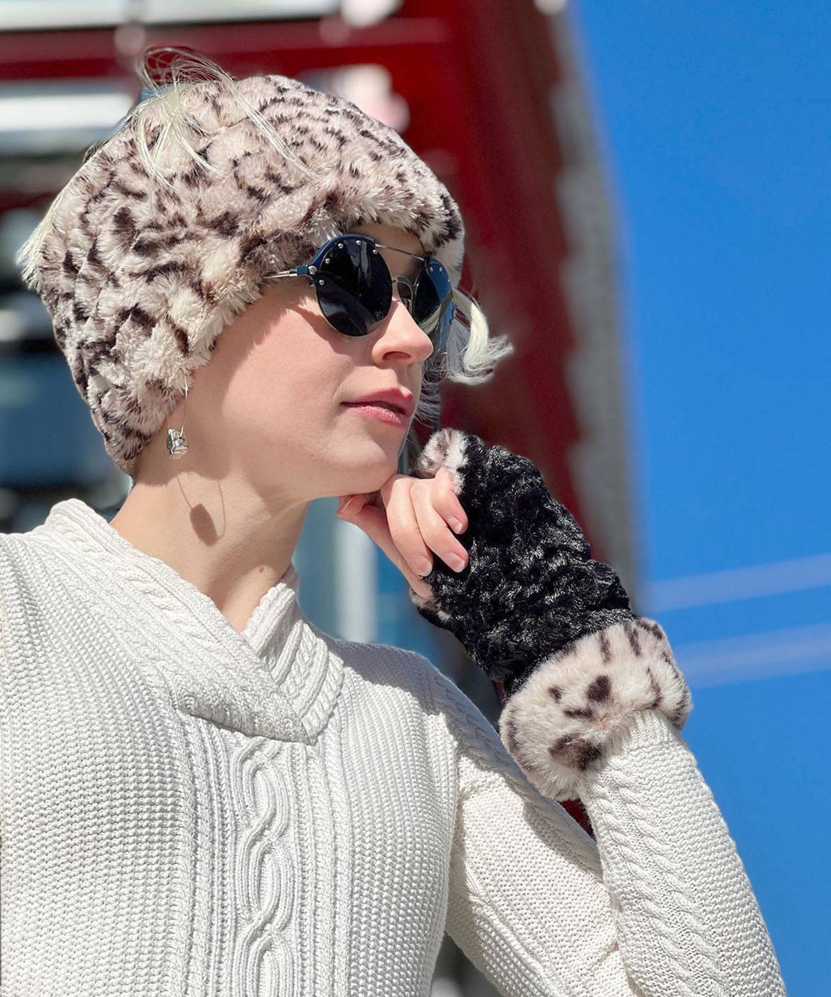 Model wearing Royal Opulence Fingerless Gloves in Snow Leopard and matching wide headband. Made in Seattle, WA, USA. Pandemonium Seattle.